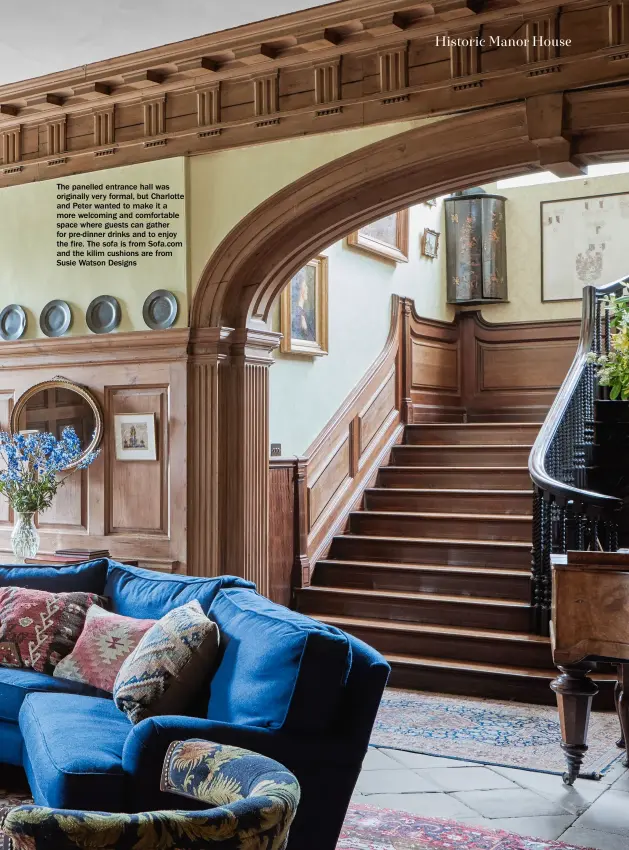  ??  ?? The panelled entrance hall was originally very formal, but Charlotte and Peter wanted to make it a more welcoming and comfortabl­e space where guests can gather for pre-dinner drinks and to enjoy the fire. The sofa is from Sofa.com and the kilim cushions are from Susie Watson Designs