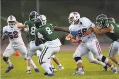  ?? Paul Ghiglieri / St. Ignatius ?? St. Ignatius’ Seta Netane (52) and Jack Burnett (59) take on blockers to stop a Sacred Heart Cathedral play on April 9.