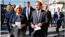  ??  ?? Stefan Lofven, leader of the Social Democratic Party and prime minister of Sweden, arrives with his wife, Ulla, to cast his vote in Stockholm, Sweden, on Sunday. “This election is a referendum about our welfare,” Lofven said.