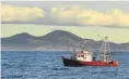  ?? PHOTO: STEPHEN JAQUIERY ?? Saddle Hill sits behind the Careys Bay fishing boat Aquarius as it trawls for fish off the Otago coast.