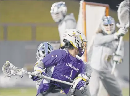  ?? Phoebe Sheehan / times union ?? ualbany attack tehoka nanticoke pivots around the goal to score during a scrimmage against Siena on feb. 8 at ualbany Casey Stadium in Albany. Without getting specific, coach Scott marr suggested last season’s America east rookie of the Year is playing through an injury.