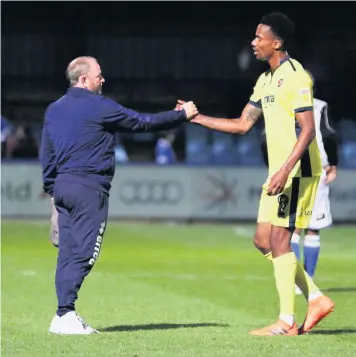  ??  ?? Gary Johnson with goal scorer Manny Duku at the final whistle at Moss Rose on Tuesday night - but Duku’s goal was not enough to save Johnson from the sack