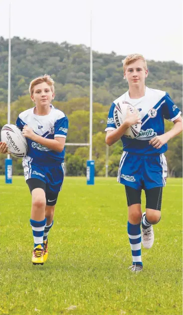  ?? Picture: BRENDAN RADKE ?? BRING IT ON: Cairns Brothers juniors Ben and Ryan Callaghan can’t wait to cheer on their NRL teams in the new season.