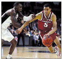  ?? AP/MICHAEL DWYER ?? Arkansas’ Jalen Harris (right) drives past Providence’s Maliek White during the second half of the teams’ first-round NIT game Tuesday in Providence, R.I. Harris had 7 points, 6 assists, 5 rebounds and 3 steals as the Razorbacks won 84-72. More photos are available at arkansason­line.com/galleries.