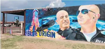  ?? THE ASSOCIATED PRESS ?? The side of a building in Van Horn, Texas, is adorned with a mural of Blue Origin founder Jeff Bezos, who plans to launch into space today from his spaceport about 50 kilometres outside the West Texas town.