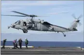  ?? MASS COMMUNICAT­ION SPECIALIST SEAMAN IAN KINKEAD — U.S. NAVY VIA AP ?? An MH-60S Sea Hawk helicopter prepares to land on the flight deck of the aircraft carrier USS Nimitz in the Pacific Ocean.