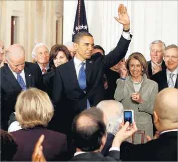  ?? Chip Somodevill­a Getty Images ?? THE CONSUMER bureau has been a target of business leaders and industry trade groups that view its approach as heavy-handed and paternalis­tic. Above, the president signs the Affordable Care Act in 2010.