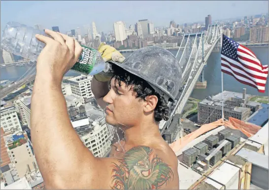  ?? [THE ASSOCIATED PRESS FILE PHOTO] ?? Constructi­on worker Eric Yanega pours water over his face as he takes a break from pouring concrete one summer at a high-rise building project in Brooklyn, N.Y. An Associated Press analysis of records from 1999-2019 shows high-temperatur­e records are being set twice as often in the United States as low-temperatur­e ones.