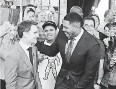  ??  ?? Ex-NFL player and TV personalit­y Michael Strahan greets Gordon outside of the Good Morning America set.