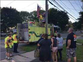  ?? PHOTOS BY CHARLES PRITCHARD - ONEIDA DAILY DISPATCH ?? Above and below right, Flags of Honor are installed by the Wampsville Fire Department on Court Street in Wampsville on Tuesday, Aug. 14.