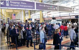  ?? YIN BOGU / XINHUA / ZUMA PRESS ?? People wait in line for preflight security checks at Ronald Reagan Washington National Airport last year in Washington D.C.