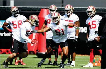  ?? AP PHOTO BY MARCIO JOSE SANCHEZ ?? San Francisco 49ers linebacker Aaron Lynch (59) and defensive lineman Arik Armstead (91) run drills during the NFL team’s football training camp Friday, in Santa Clara.