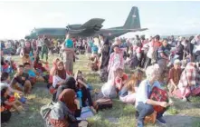  ?? — Reuters ?? Local residents affected by the earthquake and tsunami wait to be airlifted out by military planes at Mutiara Sis Al Jufri Airport in Palu.