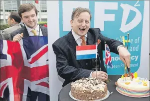  ?? AP PHOTO ?? Britain’s U.K. Independen­ce Party (UKIP) MEP Ray Finch (right) celebrates the official triggering of Article 50 of the Lisbon Treaty in Brussels on Wednesday.