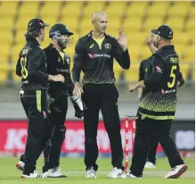  ?? Getty ?? Ashton Agar, centre, became the first Australian – and only the fifth in the world – to take six wickets in a T20 game