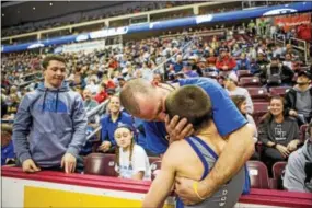  ?? NATE HECKENBERG­ER — FOR DIGITAL FIRST MEDIA ?? Downingtow­n West’s Doug Zapf shares a moment with his father, Joe Zapf, with older brother, Cole Zapf looking on, after winning the 106-pound state championsh­ip Saturday night.