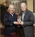  ??  ?? Dermot Brennan presents the Internatio­nal Merit award to Tom Cavanagh of Bray Runners and Slí Cualann.