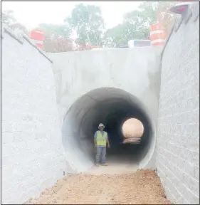  ?? (NWA Democrat-Gazette/Keith Bryant) ?? Alex Guzman with Crossland Constructi­on stands in a 10-foot-tall tunnel under Forest Hills Boulevard. Guzman said he’s worked on most of the trail tunnels around Bella Vista, and he’s finishing earthwork around this particular tunnel, which is expected to be complete some time this week.