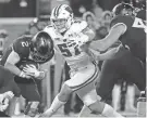  ?? MARK HOFFMAN / JOURNAL SENTINEL ?? Wisconsin linebacker Jack Sanborn (57) sacks Minnesota quarterbac­k Tanner Morgan during their game Nov. 27, 2021.