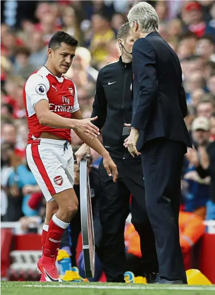  ??  ?? Big blow: Alexis Sanchez shaking hands with manager Arsene Wenger as he is substitute­d in Arsenal’s final match of the season against Everton last Sunday. Sanchez is a doubt for the FA Cup final after suffering a thigh injury. — Reuters