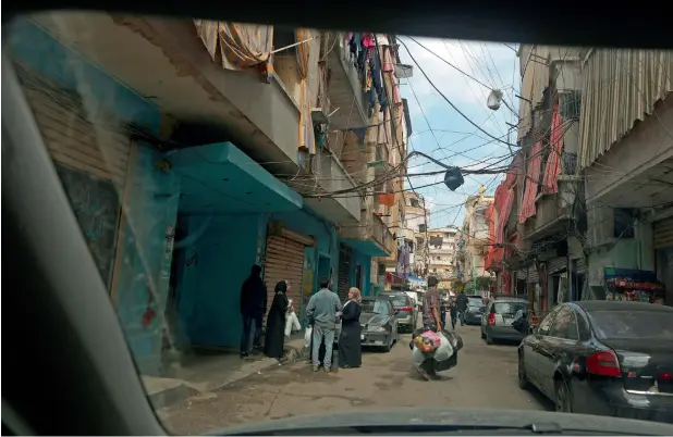  ?? — AFP File ?? A street covered with electrical wires is seen through the windshield of a car in Beirut. Citizens often complain about lawlessnes­s on the roads as drivers rarely abide by road safety rules.