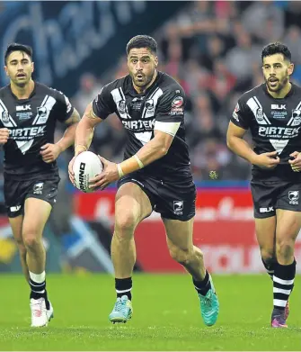  ??  ?? New Zealand half-back Shaun Johnson powers forward against England.