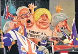  ?? REUTERS ?? A caricature of Britain's Prime Minister Theresa May (right) Boris Johnson (centre) and Michael Gove is paraded by anti-Brexit protesters in London.