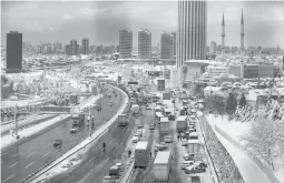  ?? EMRAH GUREL/AP ?? Hundreds of vehicles block a main road Tuesday in Istanbul. More than 31 inches of snow fell in some parts of Turkey. Greece was also slammed with a winter storm.