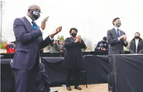  ?? AP PHOTO/PATRICK SEMANSKY ?? Georgia Democratic candidate for U.S. Senate Raphael Warnock, left, applauds as President-elect Joe Biden speaks at a drive-in rally for Warnock and Jon Ossoff, right, on Tuesday, in Atlanta. Standing in between them is Stacey Abrams.