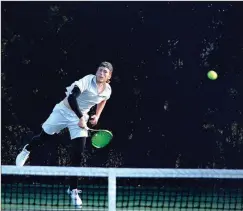  ?? Photos by TIM GODBEE / For the Calhoun Times ?? ( Calhoun’s Matthew Turner watches the ball over the net during his doubles match on Thursday. ( Calhoun’s Emma King follows through on her serve during Thursday’s match against Bremen.