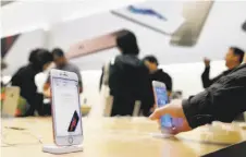  ?? Paul Chinn / The Chronicle ?? The iPhone 6S and 6S Plus, which are now available, are displayed at the Apple Store on Stockton Street in San Francisco.