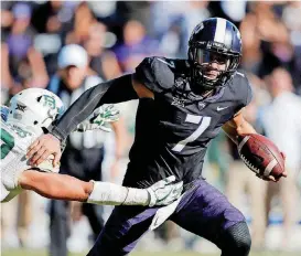  ?? [AP PHOTO] ?? TCU quarterbac­k Kenny Hill evades a tackle from Baylor linebacker Jordan Williams during the second half of Friday’s game in Fort Worth, Texas.