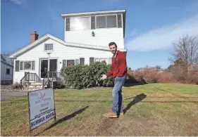  ?? ?? John Guy, an agent of Jean Knapp Rentals, poses in front of a short-term rental property on Nubble Road in York. The house is one of the many that could be affected by new regulation­s on short-term rentals in the town.