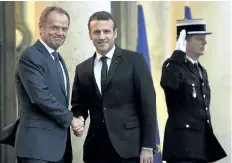  ?? STEPHANE DE SAKUTIN/THE ASSOCIATED PRESS ?? French President Emmanuel Macron, middle, shaking hands with European Council President Donald Tusk on Wednesday. Macron named a mix of prominent and unknown figures from the left and the right Wednesday to make up the government tasked with pushing...