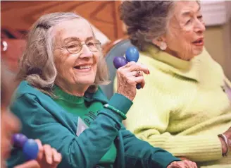  ?? PHOTOS BY STAN CARROLL/THE COMMERCIAL APPEAL ?? Eva, a client at Page Robbins Adult Day Center, participat­es in a sing-a-long at the center. The Colliervil­le center will soon receive a donation of adjacent land which the center envisions converting into a woodland garden with conifers, rhododendr­on...