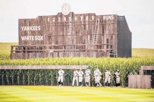  ?? JOHNNY MILANO/THE NEW YORK TIMES ?? In a nod to the movie, players for the Yankees and White Sox entered the stadium through cornfields ahead of the “Field of Dreams” game on Aug. 12 in Dyersville, Iowa, where a newly constructe­d, 8,000 capacity stadium was built adjacent to the movie set field. The Cubs and Reds will play in this year’s edition.