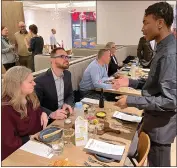  ?? ?? Cafe Momentum intern Chris, 17, of Pittsburgh, checks on guests Kate and Bill Shimko of Observator­y Hill during an invitation-only dinner at the Forbes Avenue restaurant on Feb. 6in downtown Pittsburgh.