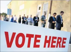  ?? Ron Jenkins Getty Images ?? VOTERS in Fort Worth. Crystal Mason, on probation for a 2012 felony conviction, broke Texas law by voting in the 2016 election before her sentence was complete.
