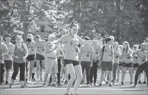  ?? COLIN CHISHOLM ?? Stephanie Cummings, dance instructor and English teacher at King’s-Edgehill School, warmed up the participan­ts with a dance routine at the school’s newly minted soccer turf.