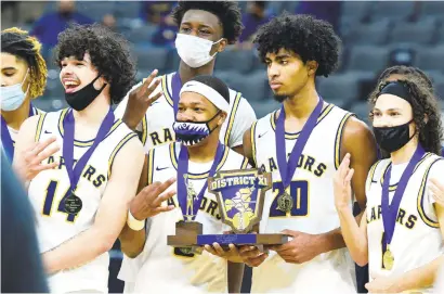  ?? RICK KINTZEL PHOTOS ?? Executive Charter’s Jevin Muniz (14), Jalil Schenck (3), Jeremiah Bembry (20), Rylan Muniz (1) and other teammates stand with the District 11 championsh­ip trophy after defeating Notre Dame-Green Pond 81-68 last March in the District 11 3A title game at PPL Center in Allentown.