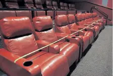  ?? Provided by Marcus Theatres ?? Yellow tape closes a line of seats at Marcus Theatres for socially distanced screenings. The Aurora location of Marcus’ Movie Tavern is now open with screenings of new releases such as “Tenet” and “The New Mutants.”