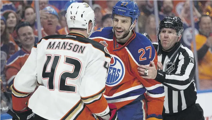  ?? DAVID BLOOM ?? Edmonton’s Milan Lucic had a few words with the Anaheim Ducks’ Josh Manson during first period NHL action at Rogers Place on Sunday.