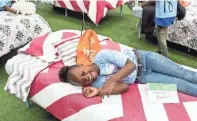  ?? BRAD ?? Aakia Patrick, 10, smiles as she lays on her new bed that she received during the Ashley HomeStore and the Memphis Tigers “Hope to Dream” event. “I think it's great,” she said while talking about her new bed. VEST/THE COMMERCIAL