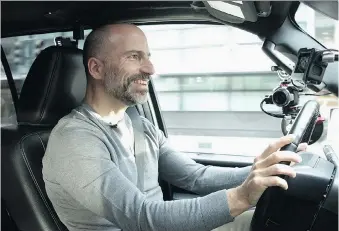  ?? UBER ?? Uber CEO Dara Khosrowsha­hi, seen testing the driver app, says the ride-hailing company is investing in the future of its platform.