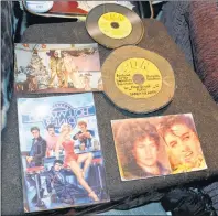  ??  ?? Some of Sandy Heartz’s mementos including a photo (lower right) showing how much he resembled Elvis in his younger years and at home with a life size cutout of Elvis (upper left).