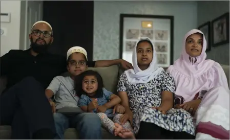  ?? JAE C. HONG — THE ASSOCIATED PRESS ?? The Zakir family, from left, father Yusuf; son Burhanuddi­n; Yusuf's niece, Insiya Maimoon; daughter Jumana; and mother Fareeda watch an episode of “Ms. Marvel” in Anaheim on July 8. Jumana`s new favorite superhero is a lot like her – female, teen, Muslim, American and “totally awesome.”