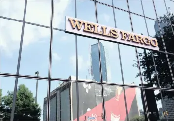  ?? PHOTO: BLOOMBERG ?? Wells Fargo signage displayed on the exterior of a bank branch in Dallas, Texas. Wells Fargo is coming under a lot of pressure for security breaches.