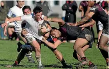  ?? PHOTO: MURRAY WILSON/FAIRFAX NZ ?? Palmerston North Boys’ High School’s Stewart Cruden tries to find an offload against Hamilton Boys’ High School.