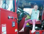 ?? DIGITAL FIRST MEDIA FILE PHOTO ?? Kaeleigh Miller looks over a Phoenixvil­le Fire Company No. 1 truck at the borough’s National Night Out observance.