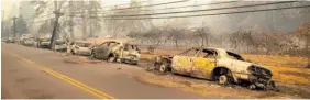  ?? Photo / AP ?? Abandoned and burnt-out vehicles litter a road out of Paradise.